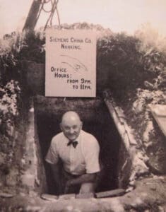 John Rabe emerging from a bunker that was used as an air raid shelter in Nanking.