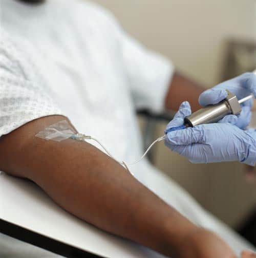 A radiotracer being inserted into a patient's arm