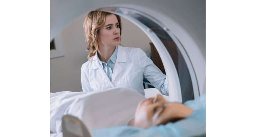doctor scanning patient in CT machine
