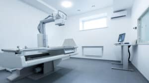 Clean and light X-ray room with chest on monitor, panorama, copy space