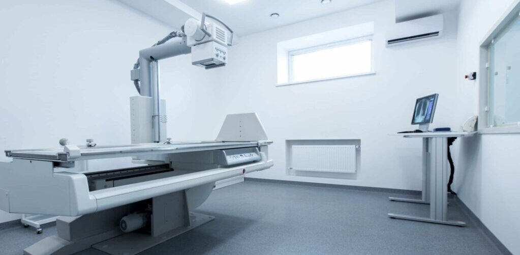Clean and light X-ray room with chest on monitor, panorama, copy space