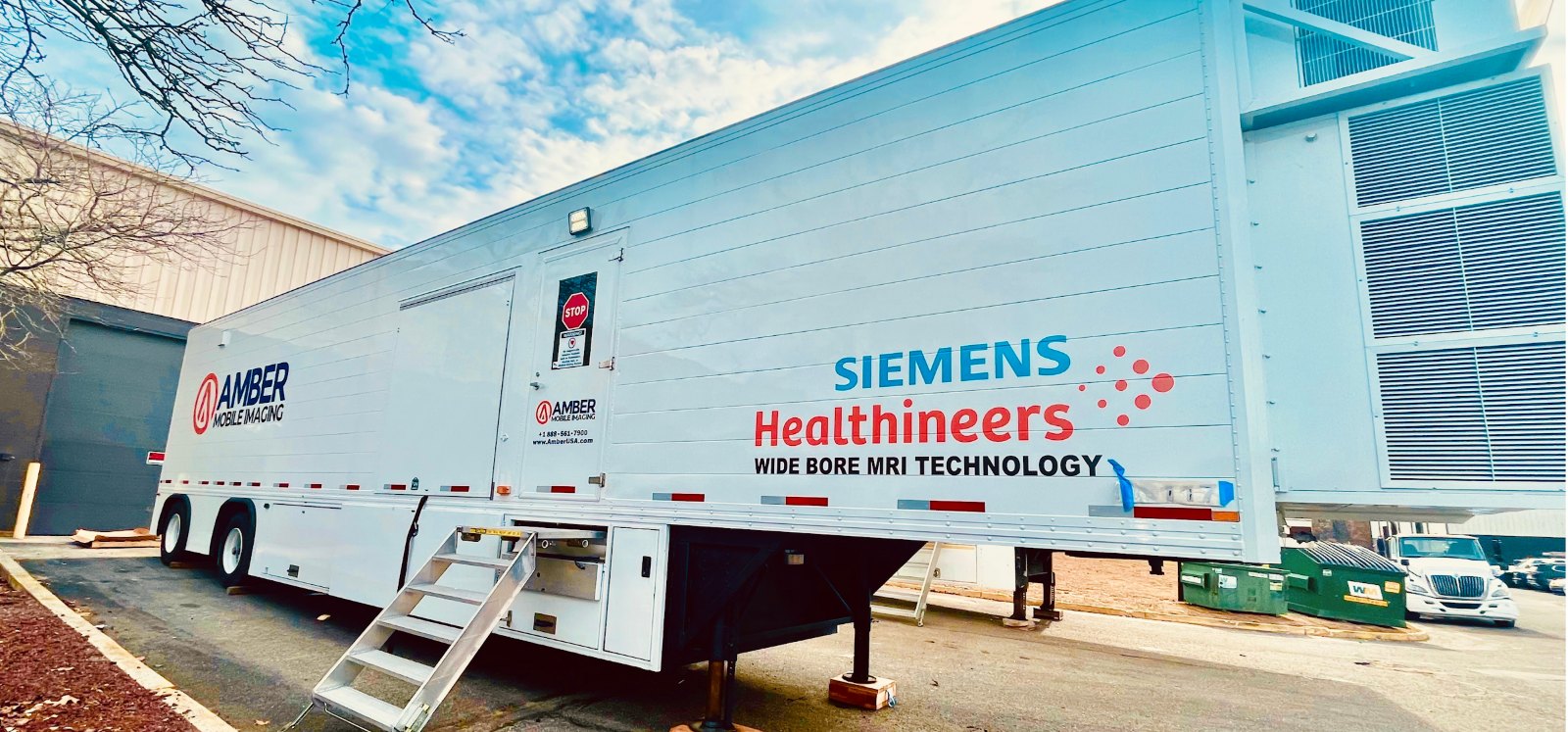 Amber Diagnostics mobile MRI trailer with a Siemens Healthineers wide-bore system parked at a facility