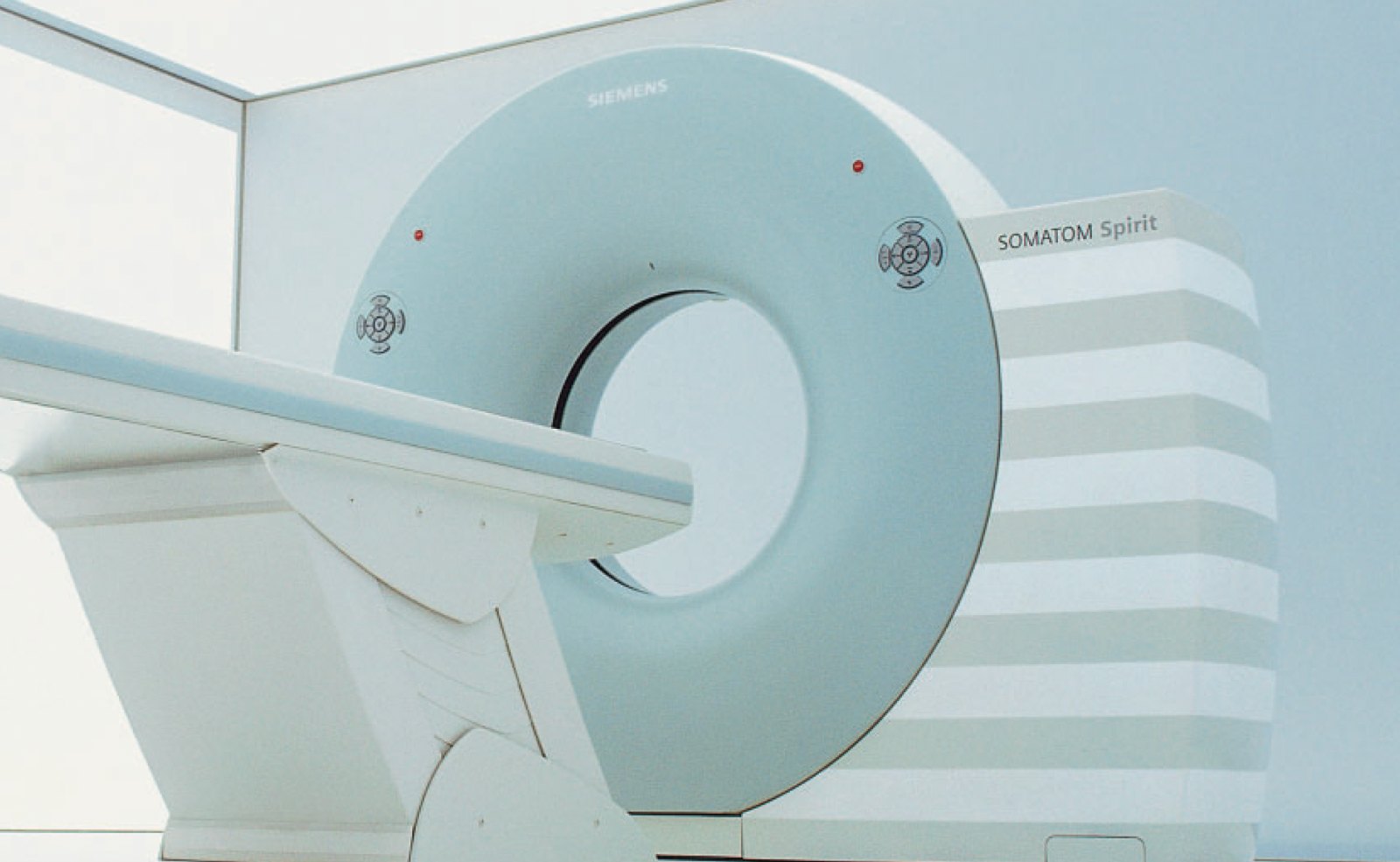 Modern CT scanner gantry and patient table installed in an imaging suite