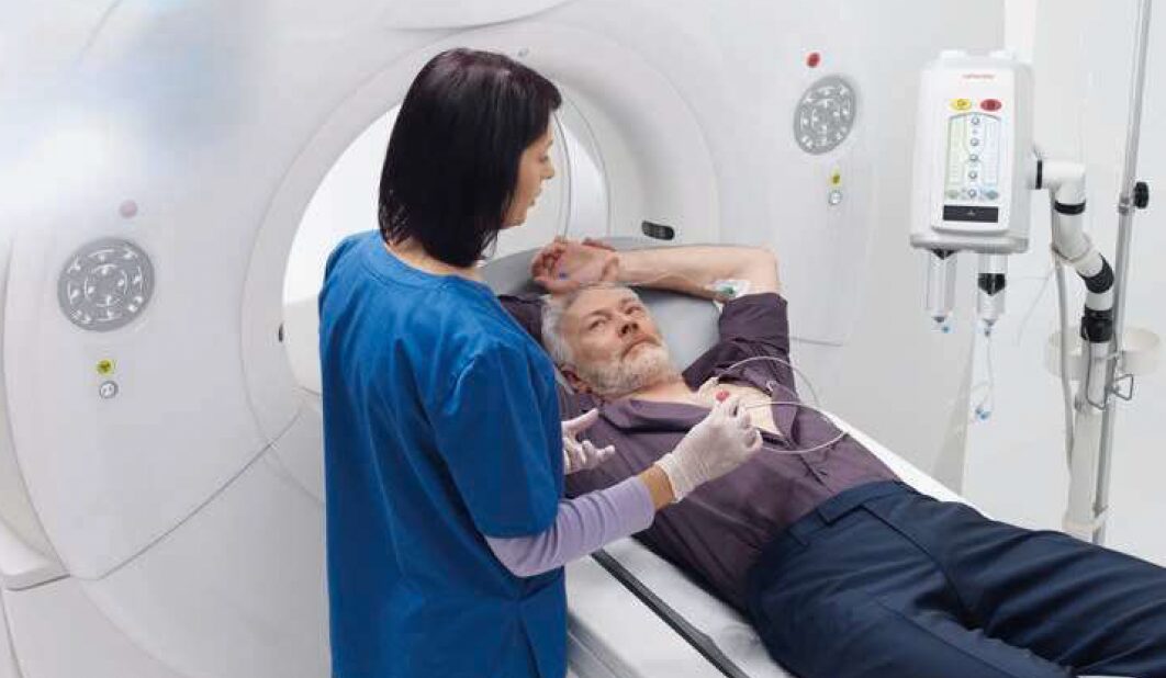 CT technologist positioning a patient before a scan